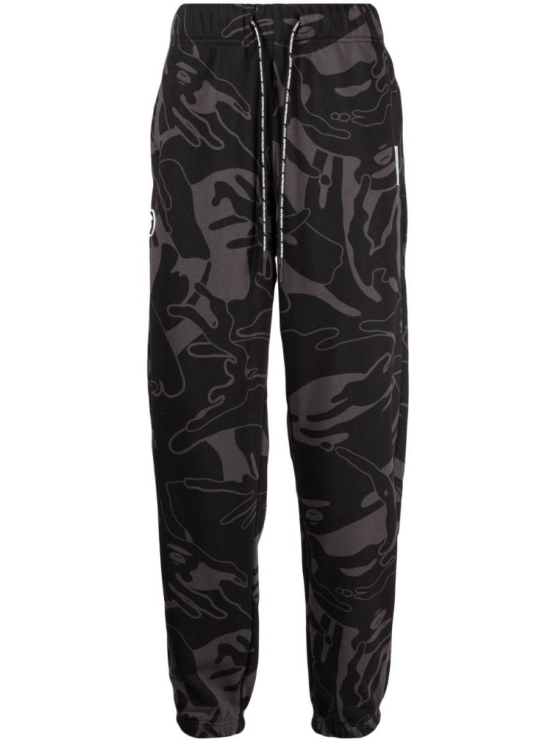 AAPE BY *A BATHING APE® graphic-print tapered trousers - Black von AAPE BY *A BATHING APE®