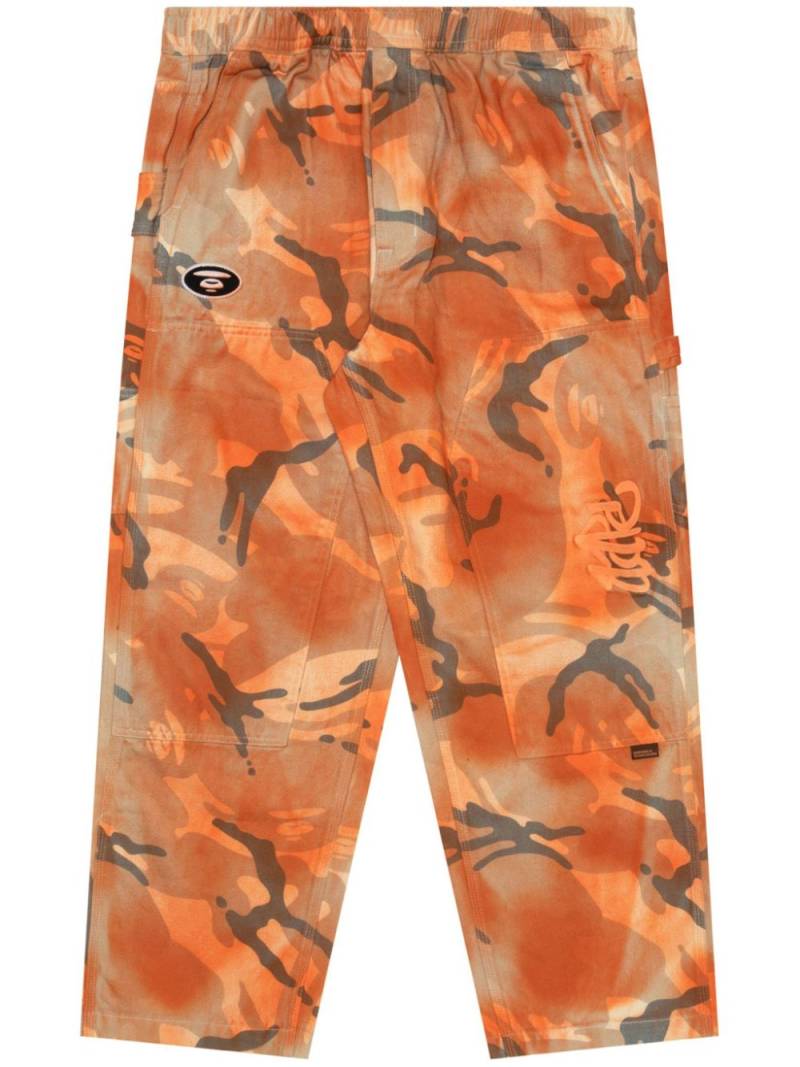 AAPE BY *A BATHING APE® spray paint-effect camouflage trousers - Orange von AAPE BY *A BATHING APE®