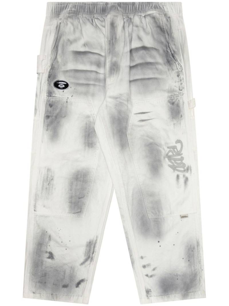 AAPE BY *A BATHING APE® spray-paint straight-leg track pants - White von AAPE BY *A BATHING APE®