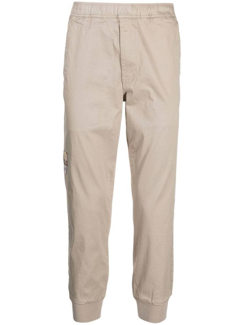 AAPE BY *A BATHING APE® stretch-cotton tapered-leg pants - Brown von AAPE BY *A BATHING APE®