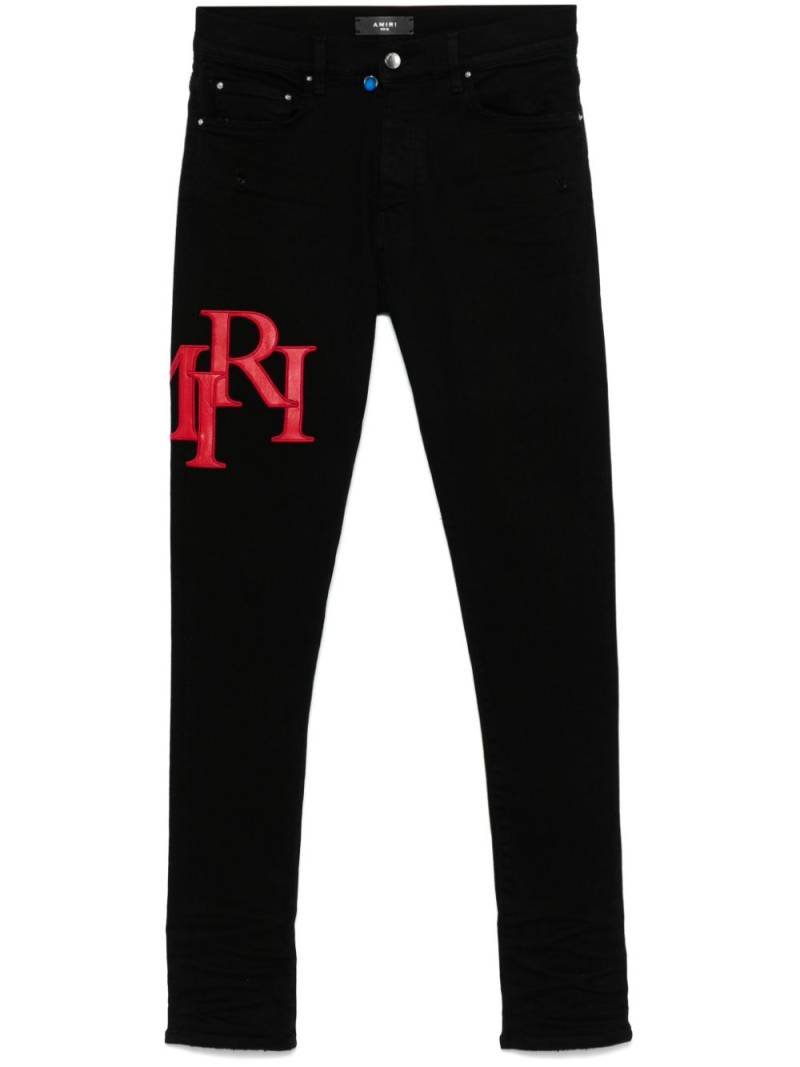 AMIRI Staggered-logo-embroidered jeans - Black von AMIRI