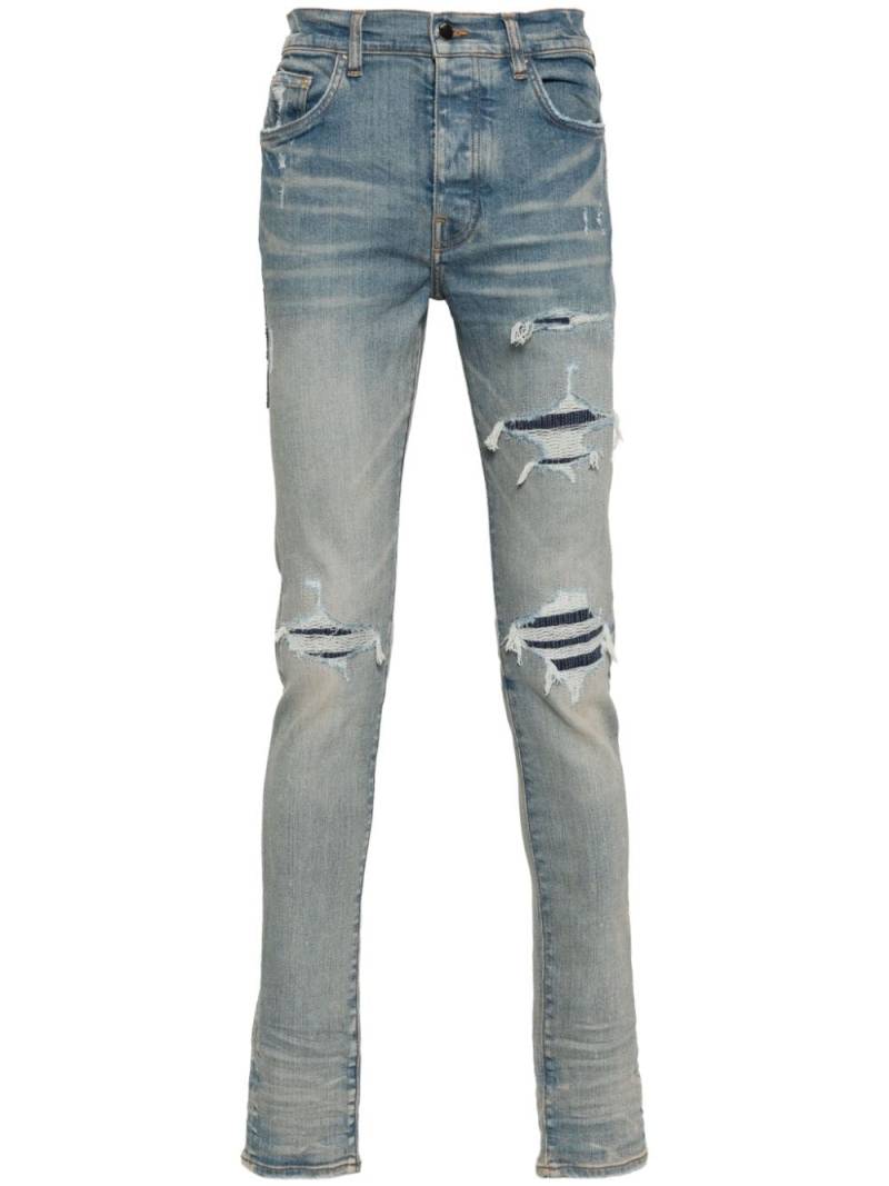 AMIRI logo-patch ripped skinny jeans - Blue von AMIRI