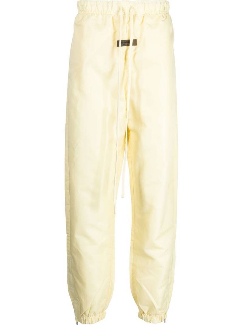 FEAR OF GOD ESSENTIALS logo-patch track pants - Yellow von FEAR OF GOD ESSENTIALS