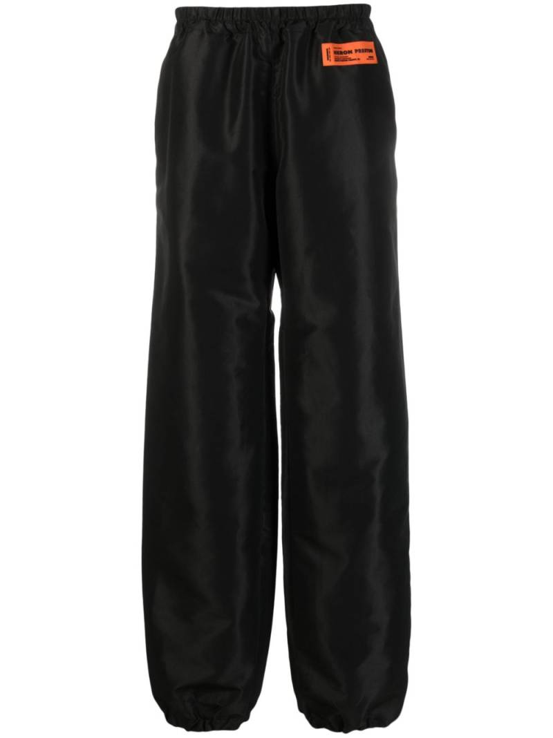 Heron Preston logo-patch wide-leg trousers - Black von Heron Preston