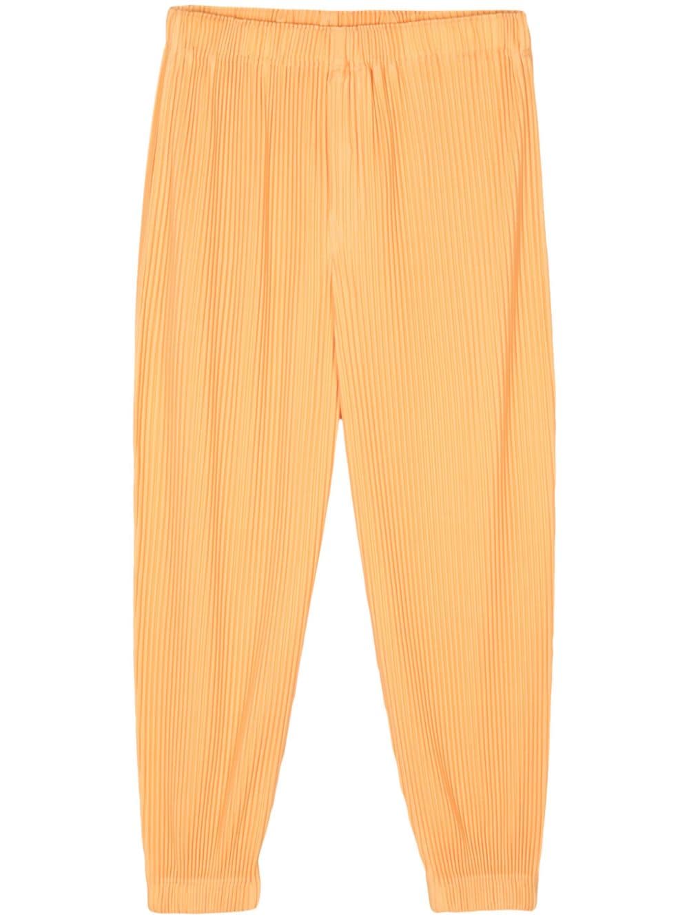 Homme Plissé Issey Miyake plissé tapered trousers - Yellow von Homme Plissé Issey Miyake