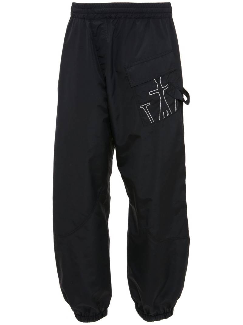 JW Anderson Anchor-embroidered twisted track pants - Black von JW Anderson