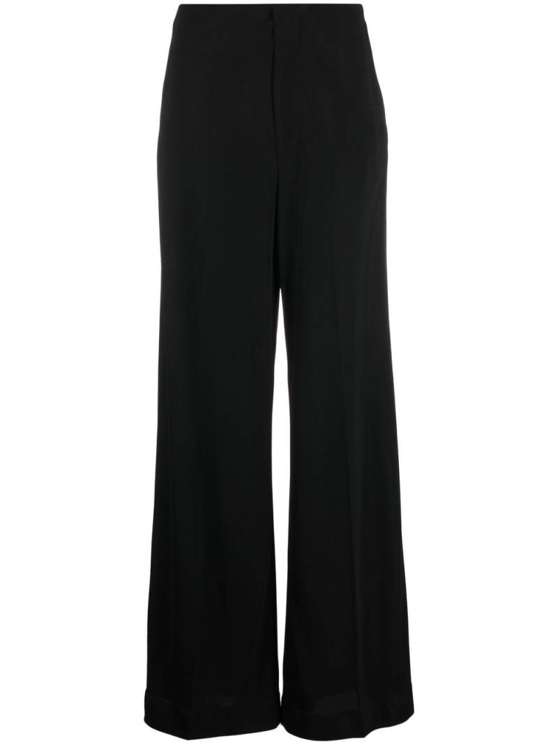 Maison Margiela pressed-crease four-stitch palazzo trousers - Black von Maison Margiela