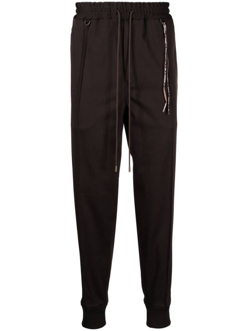 Mastermind World logo-jacquard tapered track pants - Brown von Mastermind World