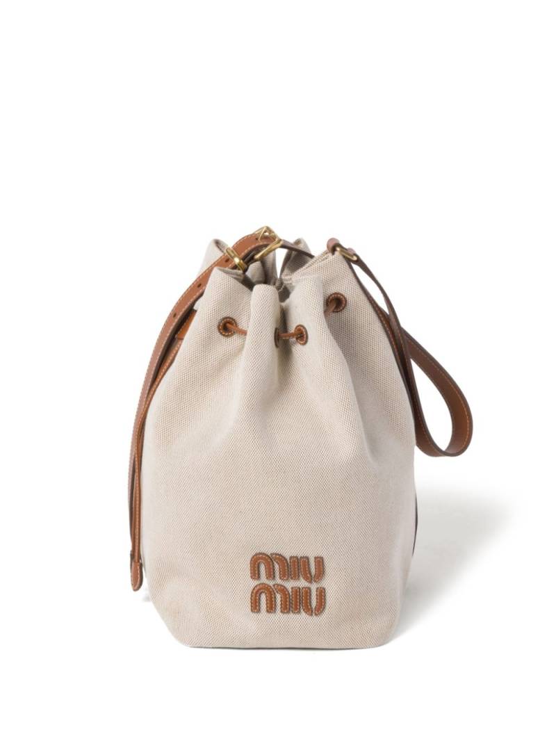 Miu Miu logo-lettering canvas bucket bag - Neutrals von Miu Miu