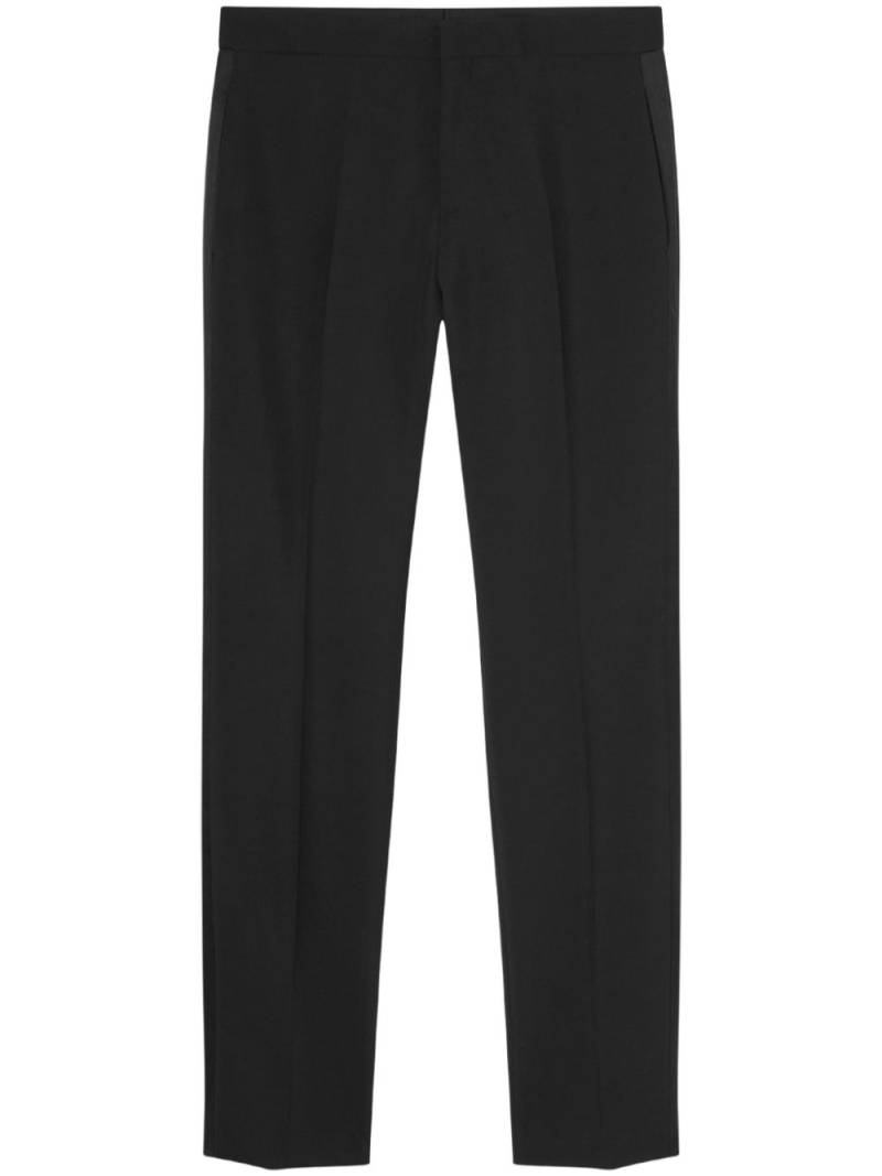 Versace logo-appliqué tapered chino trousers - Black von Versace